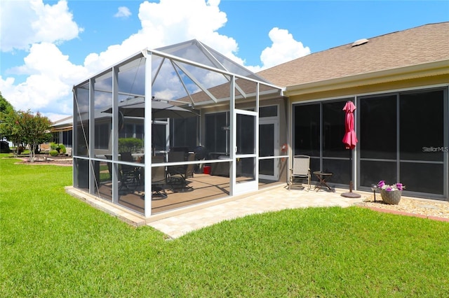 11868 SE 91st Cir, Summerfield, FL 34491 - rear view of property featuring a lawn, roof with shingles, a patio, and a lanai
