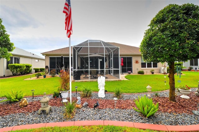 11868 SE 91st Cir, Summerfield, FL 34491 - rear view of house with a lawn, glass enclosure, a patio, and stucco siding