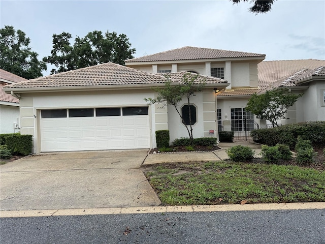 2450 Sweetwater Country Club Dr, Apopka, FL 32712 - mediterranean / spanish home with a tiled roof, driveway, an attached garage, and stucco siding