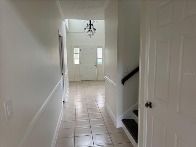 2450 Sweetwater Country Club Dr, Apopka, FL 32712 - hall featuring light tile patterned flooring, a chandelier, and baseboards