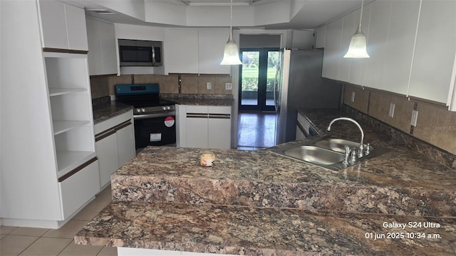 2450 Sweetwater Country Club Dr, Apopka, FL 32712 - kitchen with appliances with stainless steel finishes, a sink, and white cabinets
