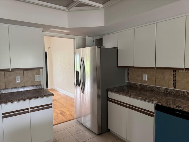 2450 Sweetwater Country Club Dr, Apopka, FL 32712 - kitchen with stainless steel refrigerator with ice dispenser, decorative backsplash, light tile patterned floors, and dark stone countertops