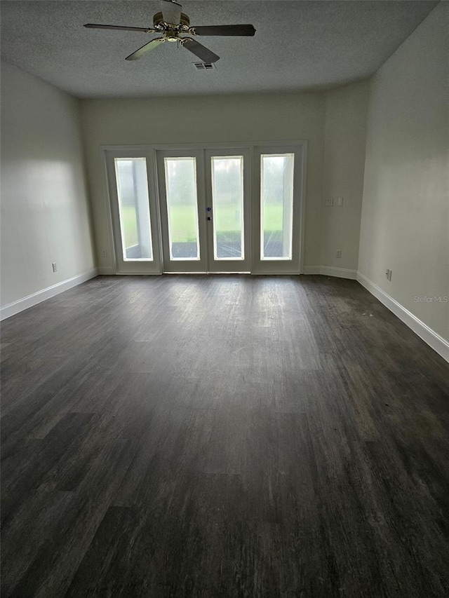 2450 Sweetwater Country Club Dr, Apopka, FL 32712 - spare room featuring healthy amount of natural light, baseboards, dark wood finished floors, and a textured ceiling