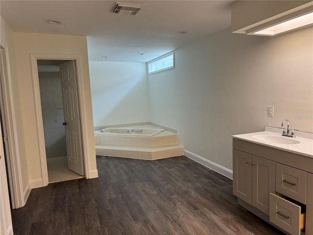 2450 Sweetwater Country Club Dr, Apopka, FL 32712 - full bathroom featuring a bath, wood finished floors, vanity, and baseboards
