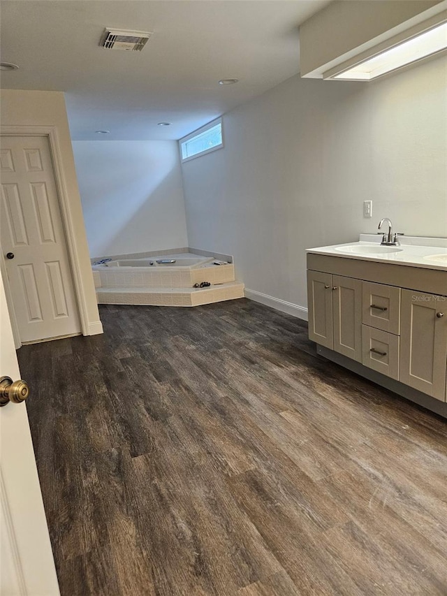 2450 Sweetwater Country Club Dr, Apopka, FL 32712 - full bath featuring vanity, a bath, wood finished floors, and baseboards