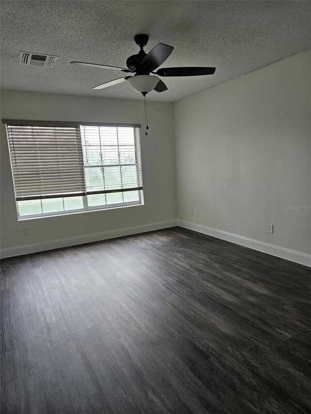 2450 Sweetwater Country Club Dr, Apopka, FL 32712 - empty room with ceiling fan, dark wood-style flooring, baseboards, and a textured ceiling