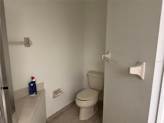 2450 Sweetwater Country Club Dr, Apopka, FL 32712 - bathroom featuring toilet, tile patterned flooring, and baseboards