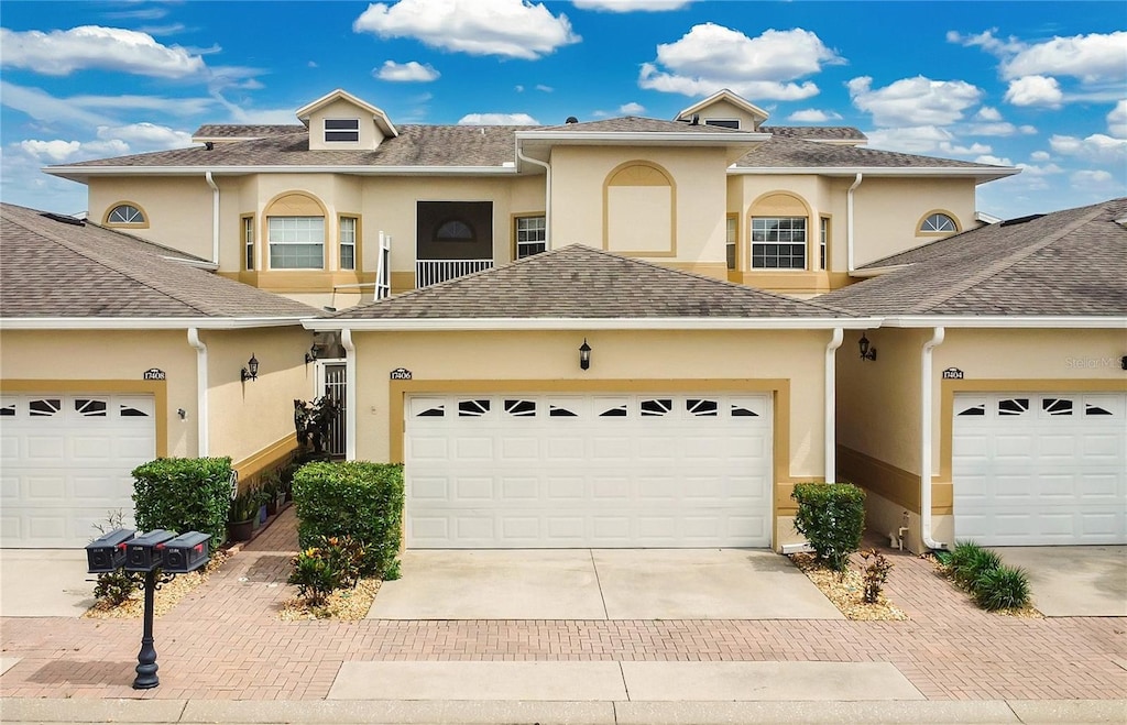 17406 Chateau Pine Way, Clermont, FL 34711 - view of property featuring stucco siding, driveway, and an attached garage