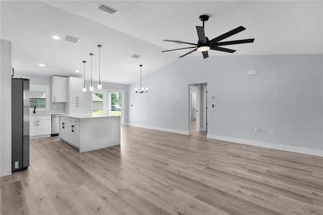 472 Malauka Radl, Ocklawaha, FL 32179 - kitchen with appliances with stainless steel finishes, open floor plan, a sink, a ceiling fan, and vaulted ceiling