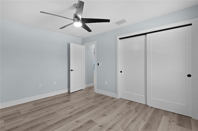 472 Malauka Radl, Ocklawaha, FL 32179 - unfurnished bedroom featuring light wood-style floors, a closet, a ceiling fan, and baseboards