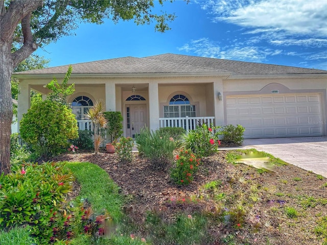 3555 Chapel Hill Blvd, Clermont, FL 34711 - view of front of property featuring a garage, covered porch, concrete driveway, and stucco siding
