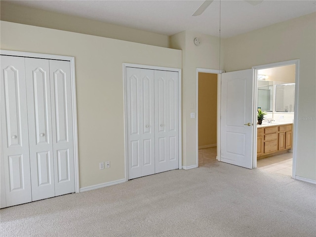 3555 Chapel Hill Blvd, Clermont, FL 34711 - unfurnished bedroom with light colored carpet, two closets, baseboards, and ensuite bath