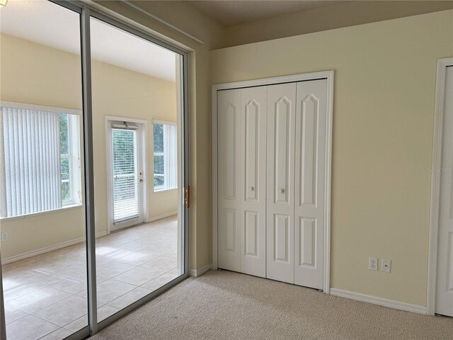 3555 Chapel Hill Blvd, Clermont, FL 34711 - unfurnished bedroom featuring a closet, baseboards, and access to outside