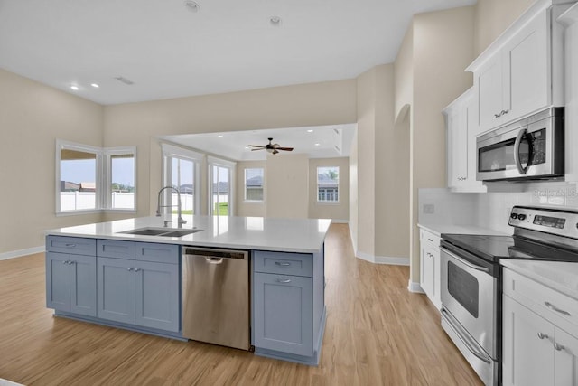 5556 Vintage View Blvd, Lakeland, FL 33812 - kitchen featuring appliances with stainless steel finishes, a sink, white cabinetry, baseboards, and recessed lighting