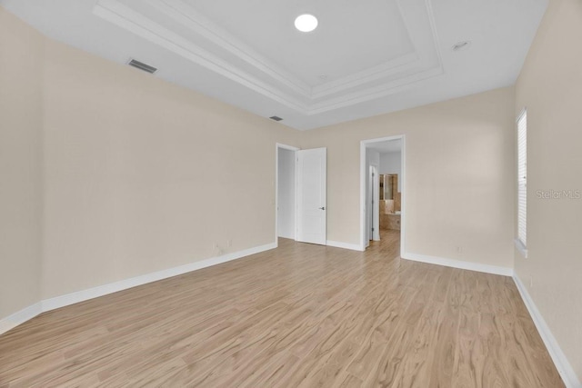 5556 Vintage View Blvd, Lakeland, FL 33812 - empty room with a tray ceiling, light wood-style flooring, ornamental molding, and baseboards
