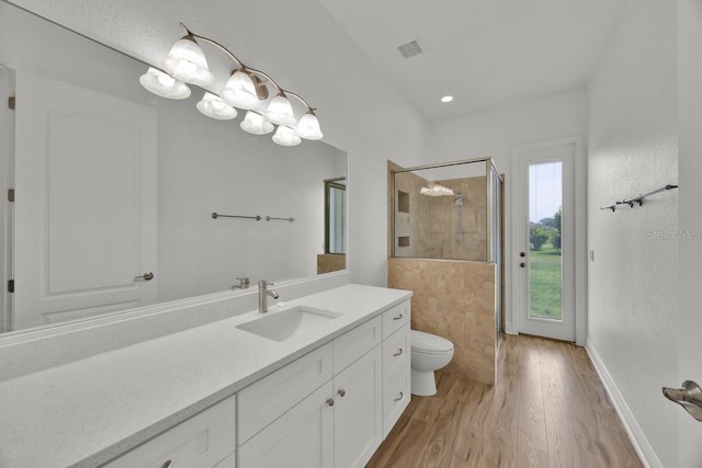 5556 Vintage View Blvd, Lakeland, FL 33812 - bathroom featuring toilet, wood finished floors, vanity, a stall shower, and baseboards