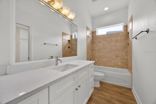 5556 Vintage View Blvd, Lakeland, FL 33812 - full bathroom with vanity, toilet, wood finished floors, and washtub / shower combination