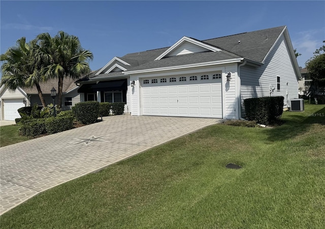 2530 Hanlon Ter, The Villages, FL 32162 - single story home with an attached garage, cooling unit, driveway, a front lawn, and roof with shingles