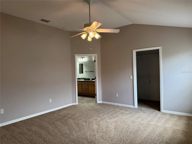 2530 Hanlon Ter, The Villages, FL 32162 - unfurnished bedroom featuring light carpet, lofted ceiling, baseboards, a closet, and connected bathroom