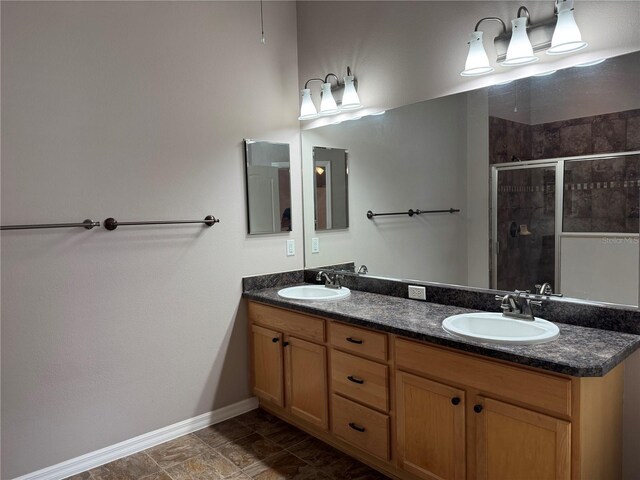 2530 Hanlon Ter, The Villages, FL 32162 - bathroom featuring baseboards, double vanity, and a stall shower