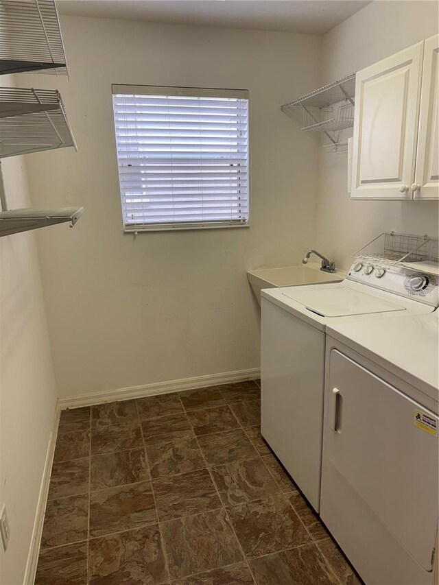 2530 Hanlon Ter, The Villages, FL 32162 - laundry room with baseboards, cabinet space, and washing machine and dryer