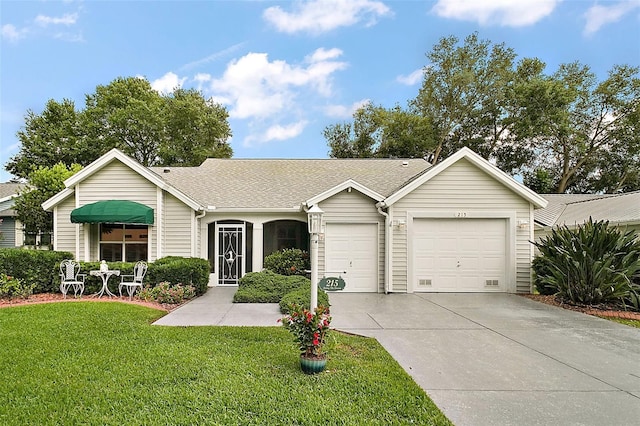 215 Chula Vista Ave, The Villages, FL 32159 - ranch-style home with a garage, driveway, a front yard, and roof with shingles