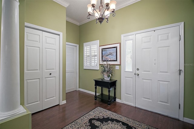 215 Chula Vista Ave, The Villages, FL 32159 - foyer with crown molding, a chandelier, dark wood-style floors, baseboards, and ornate columns