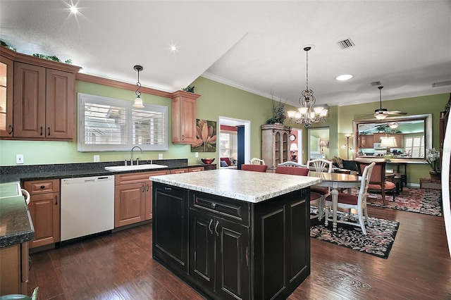 215 Chula Vista Ave, The Villages, FL 32159 - kitchen with white dishwasher, a sink, hanging light fixtures, dark wood-style floors, and crown molding