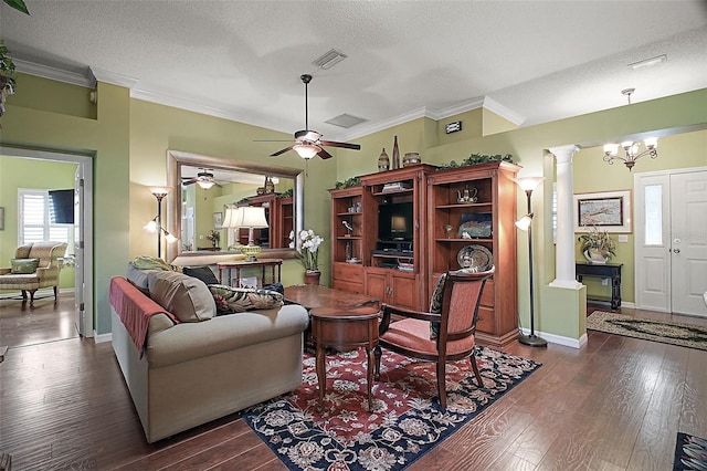 215 Chula Vista Ave, The Villages, FL 32159 - living area with decorative columns, dark wood-style floors, a ceiling fan, ornamental molding, and a textured ceiling