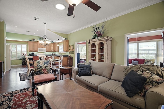 215 Chula Vista Ave, The Villages, FL 32159 - living room featuring wood finished floors, a ceiling fan, a chandelier, baseboards, and ornamental molding