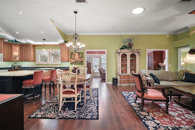 215 Chula Vista Ave, The Villages, FL 32159 - dining space with dark wood-type flooring, a chandelier, and crown molding