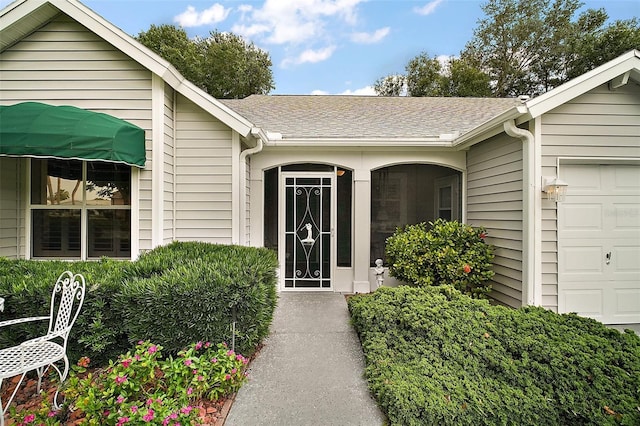 215 Chula Vista Ave, The Villages, FL 32159 - doorway to property with an attached garage and roof with shingles
