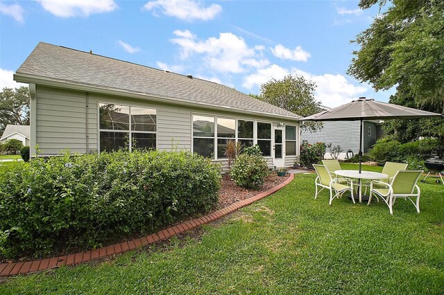 215 Chula Vista Ave, The Villages, FL 32159 - back of property with a lawn and roof with shingles