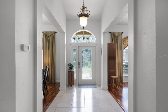 4239 Fawn Meadows Cir, Clermont, FL 34711 - foyer featuring plenty of natural light, light tile patterned floors, baseboards, and a textured wall