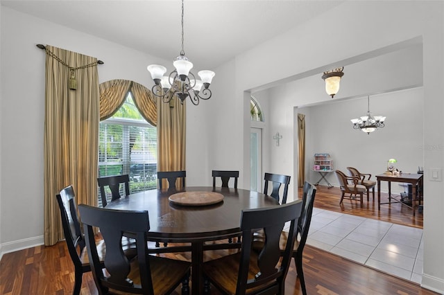 4239 Fawn Meadows Cir, Clermont, FL 34711 - dining space featuring a chandelier, wood finished floors, and baseboards