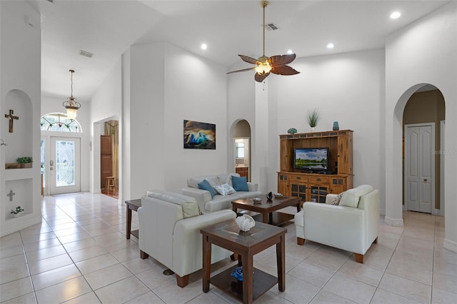4239 Fawn Meadows Cir, Clermont, FL 34711 - living room with arched walkways, a towering ceiling, a ceiling fan, light tile patterned flooring, and recessed lighting