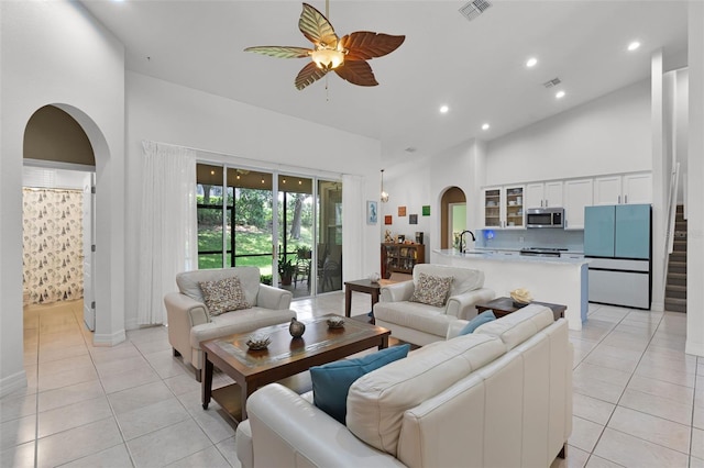 4239 Fawn Meadows Cir, Clermont, FL 34711 - living area featuring arched walkways, light tile patterned floors, a ceiling fan, a high ceiling, and recessed lighting