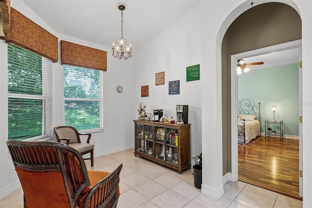 4239 Fawn Meadows Cir, Clermont, FL 34711 - sitting room with arched walkways, light tile patterned floors, a ceiling fan, baseboards, and a chandelier