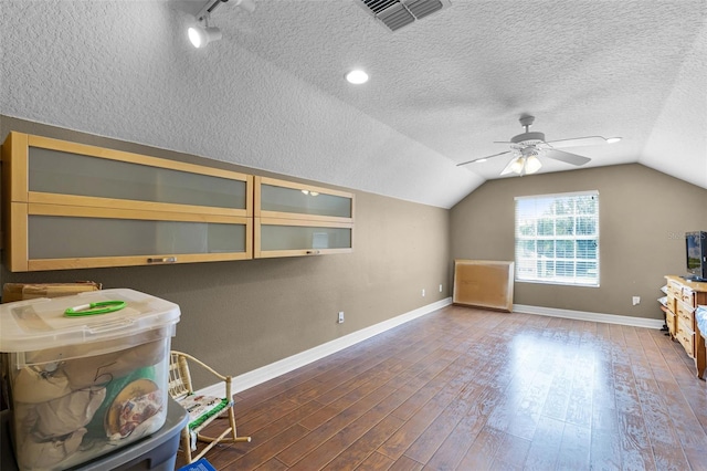 4239 Fawn Meadows Cir, Clermont, FL 34711 - additional living space with wood finished floors, vaulted ceiling, a ceiling fan, baseboards, and a textured ceiling