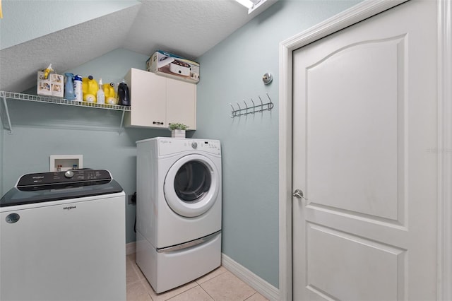 4239 Fawn Meadows Cir, Clermont, FL 34711 - washroom featuring washer and clothes dryer, cabinet space, a textured ceiling, light tile patterned flooring, and baseboards