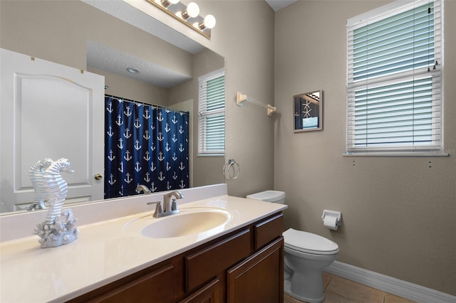 4239 Fawn Meadows Cir, Clermont, FL 34711 - bathroom with toilet, vanity, tile patterned flooring, baseboards, and curtained shower