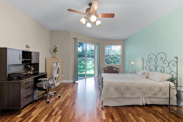 4239 Fawn Meadows Cir, Clermont, FL 34711 - bedroom featuring access to outside, wood finished floors, baseboards, a desk, and a textured ceiling