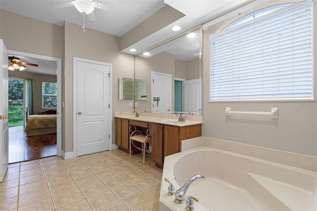 4239 Fawn Meadows Cir, Clermont, FL 34711 - full bathroom featuring a ceiling fan, connected bathroom, a garden tub, and double vanity