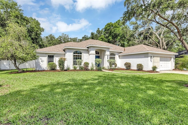 34231 Shadewood Cir, Leesburg, FL 34788 - view of front of house with an attached garage, stucco siding, driveway, and roof with shingles