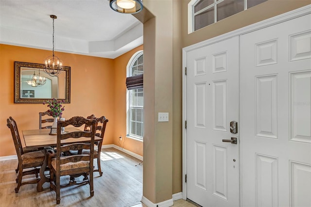 34231 Shadewood Cir, Leesburg, FL 34788 - dining room with baseboards, a chandelier, and light wood-type flooring