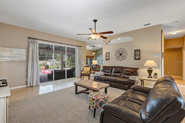 34231 Shadewood Cir, Leesburg, FL 34788 - living room with a ceiling fan, light tile patterned flooring, baseboards, and light carpet