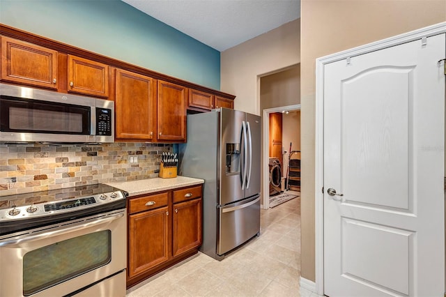 34231 Shadewood Cir, Leesburg, FL 34788 - kitchen featuring stainless steel appliances, brown cabinetry, decorative backsplash, and light tile patterned floors