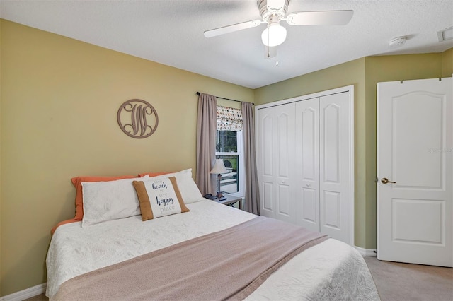 34231 Shadewood Cir, Leesburg, FL 34788 - bedroom with light carpet, a closet, baseboards, a ceiling fan, and a textured ceiling