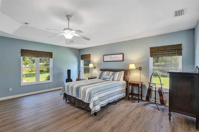 34231 Shadewood Cir, Leesburg, FL 34788 - bedroom featuring wood finished floors, baseboards, and ceiling fan