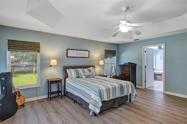 34231 Shadewood Cir, Leesburg, FL 34788 - bedroom with wood finished floors, baseboards, and ceiling fan